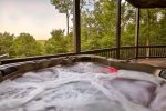 Soak up in the hot tub while enjoying the view